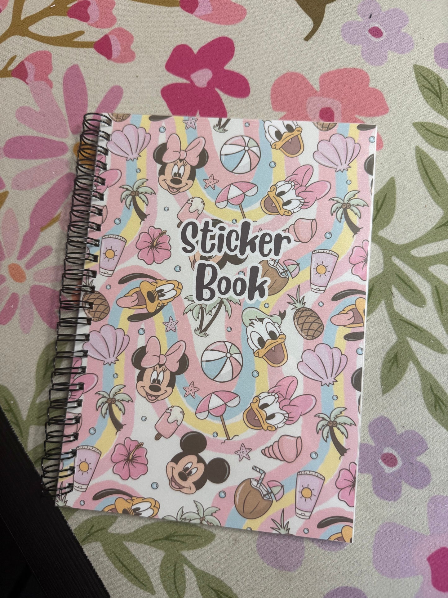 Sticker book with cartoon characters on a floral patterned surface