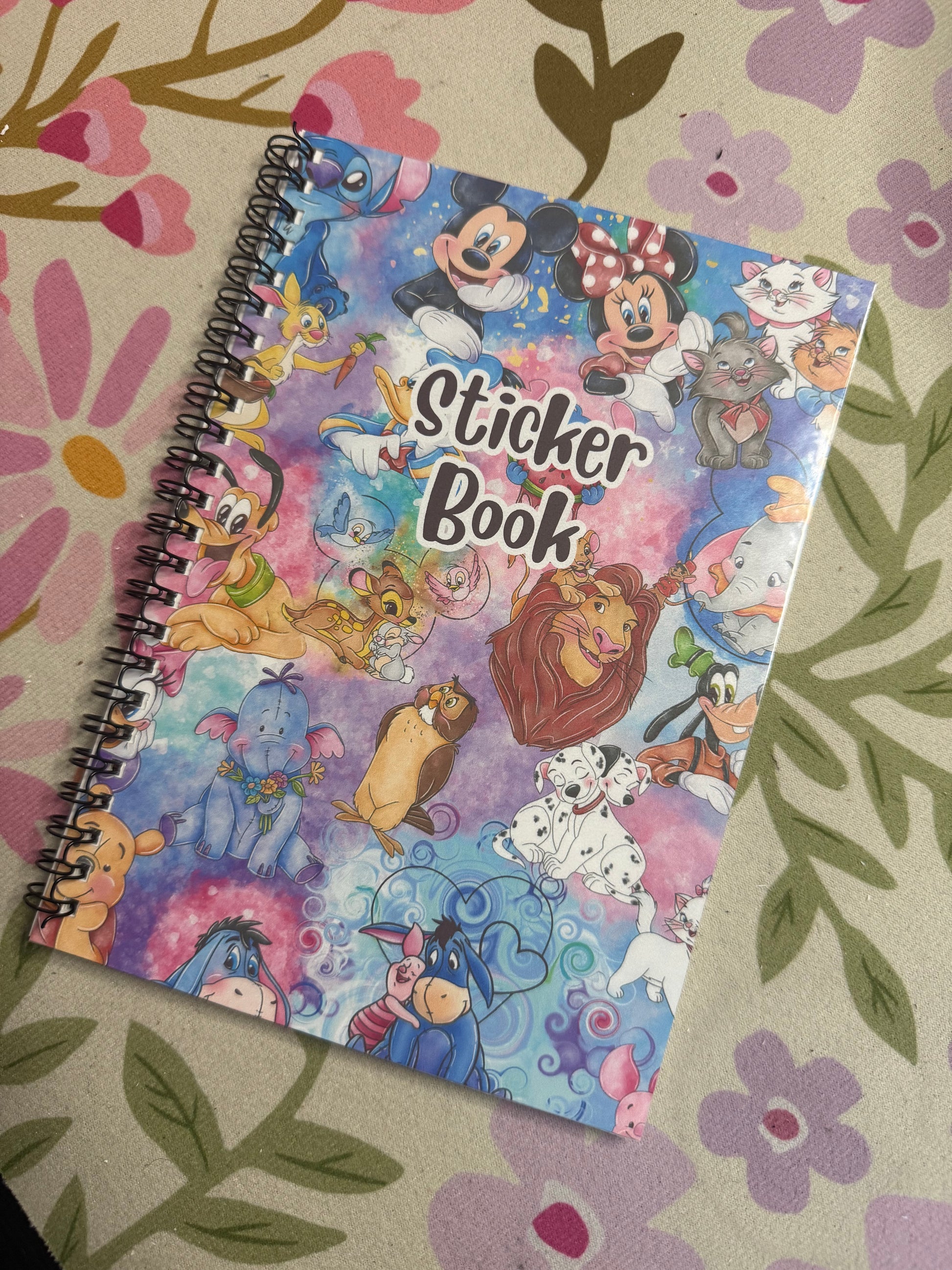 Sticker book with cartoon characters on a floral-patterned surface
