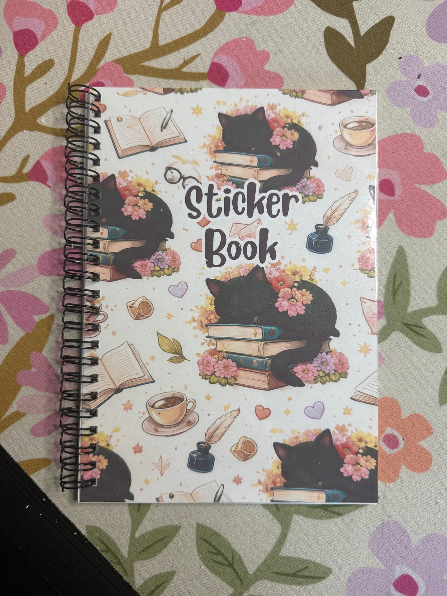 Sticker book with decorative cover on a floral background