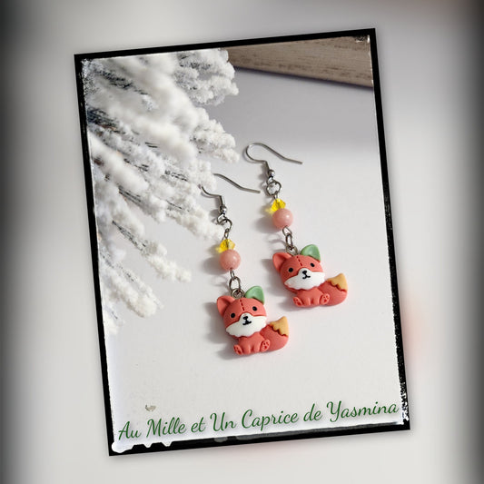 Pair of fox-shaped earrings on a card with 'Au Mille et Un Caprice de Yasmina' text.